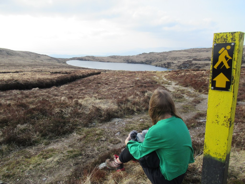 child looking at mountaintop lake on Glanaclohy walk